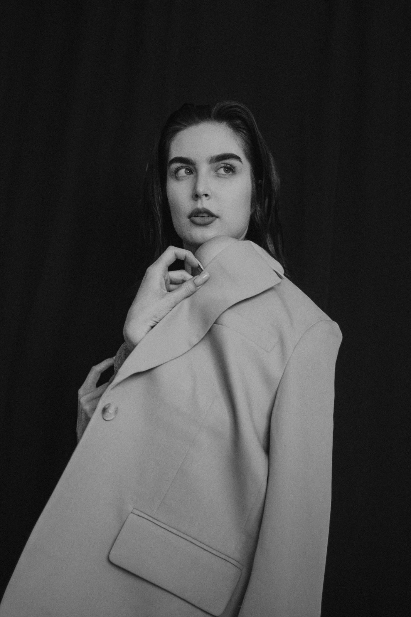 Monoloom Bone Overcoat shown on a model against a dark ground