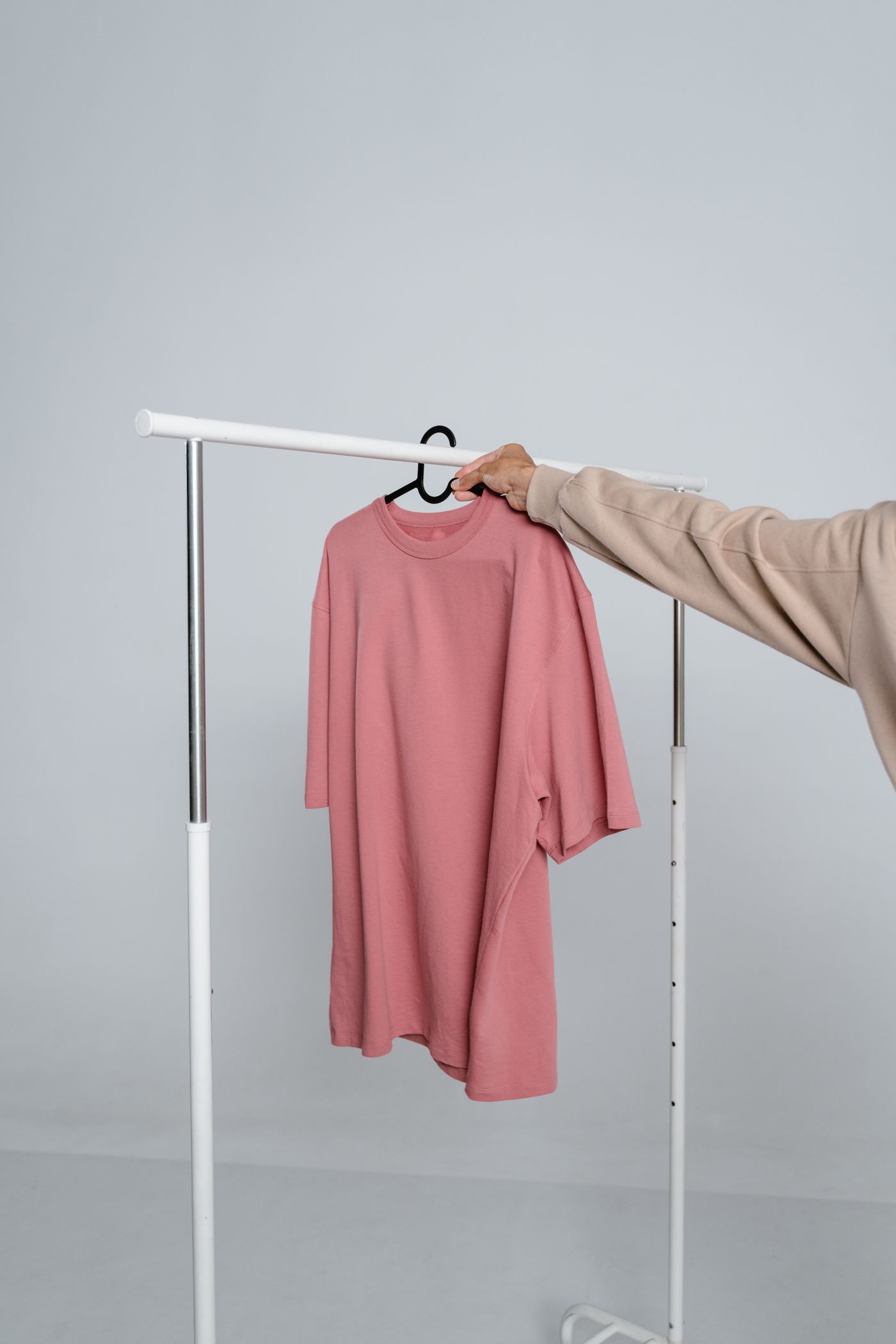 Monoloom Rail Tee held out on a hanger against a plain wall