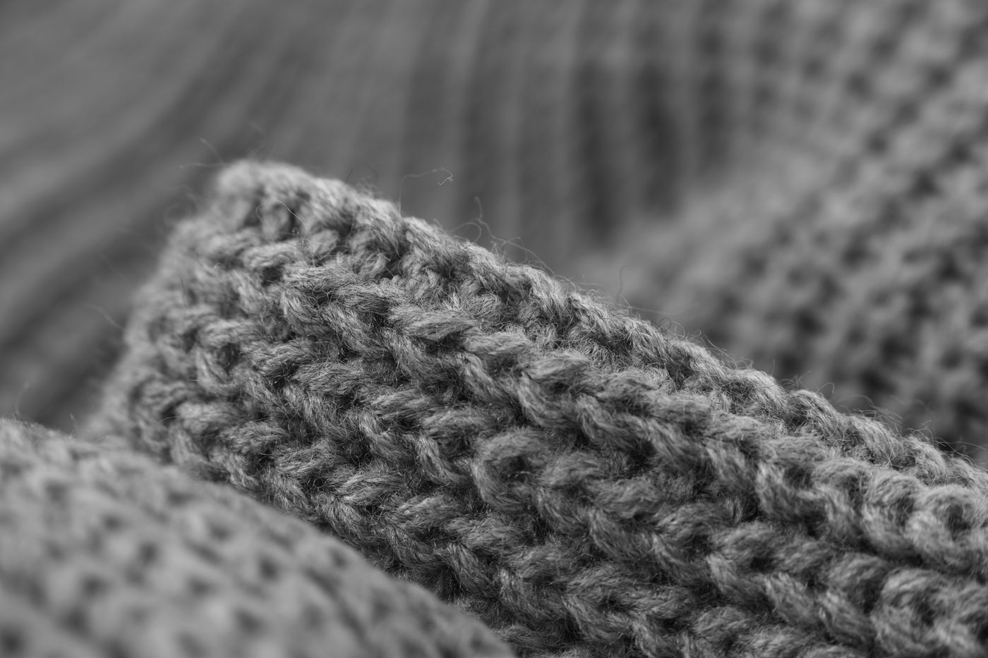 Macro photograph of a heavy knit, lit from the side to show every thread